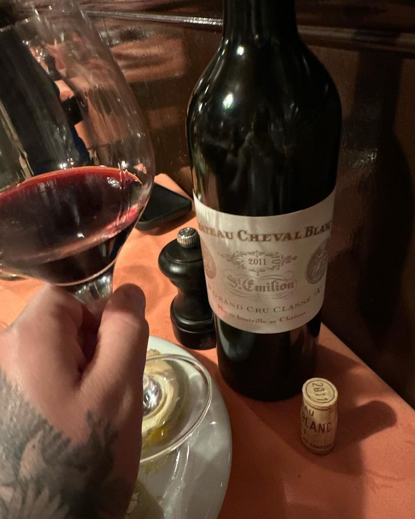 Brooklyn beckhams hand with wine bottle