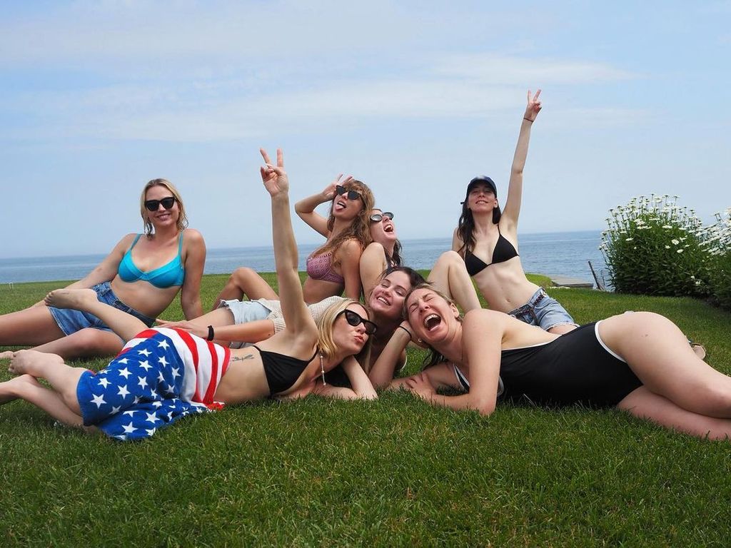 Taylor Swift, Selena Gomez, Haim, Ashley Avignone, Sydney Hess lie on the grass in swimwear