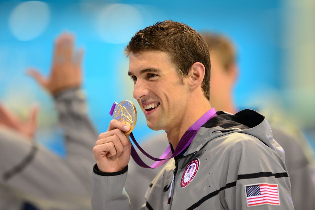 US swimmer Michael Phelps poses on the podium with the gold medal flanked by silver medalist and bronze medalist after winning the men's 4x100 medley relay final during the swimming event at the London 2012 Olympic Games on August 4, 2012 in London