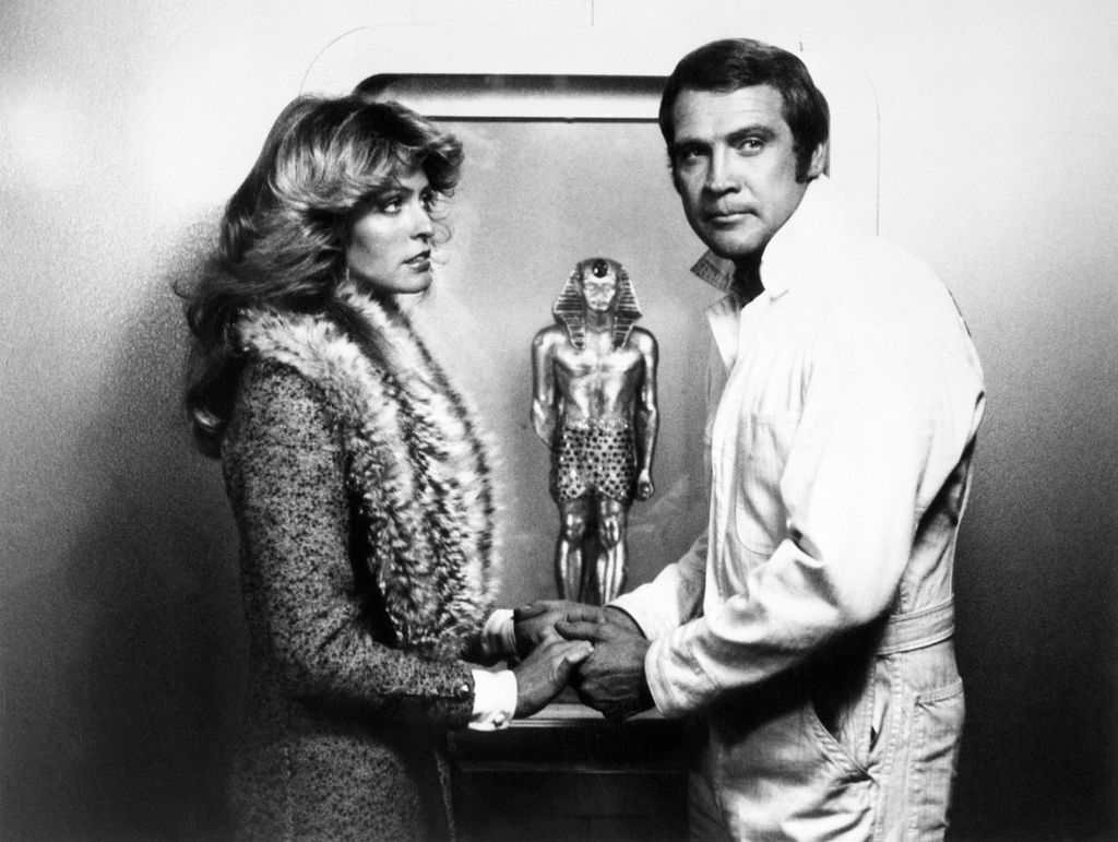  Lee Majors, as Steve Austin, persuades an old acquaintance, beautiful Trish Hollander, (played by guest star Farrah Fawcett-Majors, real-life wife of Lee) to help him in retrieving a priceless statue, the Golden Pharaoh, which has been stolen from a small country in The Golden Pharaoh on the ABC Television Network's The Six Million Dollar Man.