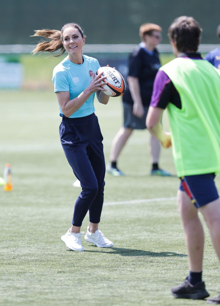 Kate throwing a rugby ball 