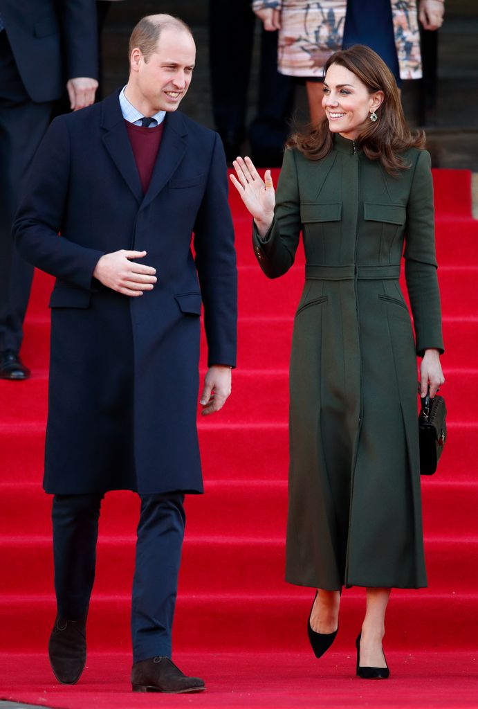 Kate in khaki coat dress waving on red steps beside prince william