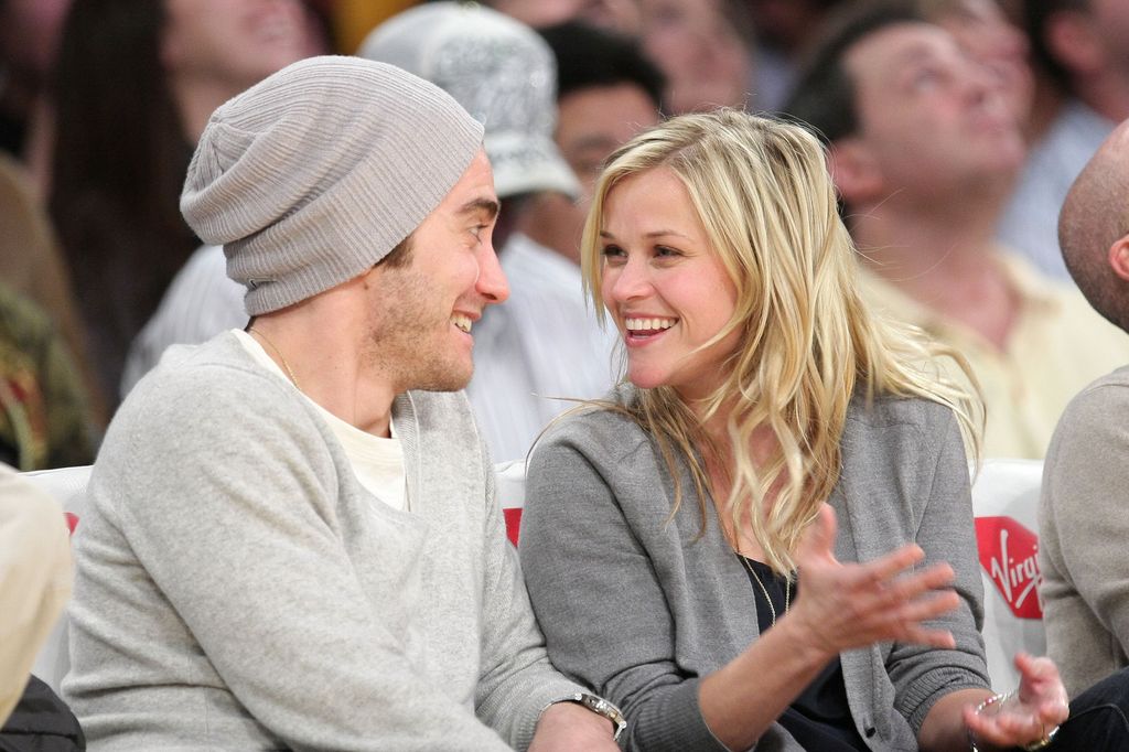 Jake Gyllenhaal and Reese Witherspoon react after kissing at the Los Angeles Lakers vs Portland Trailblazers game at the Staples Center on January 4, 2009 in Los Angeles, California