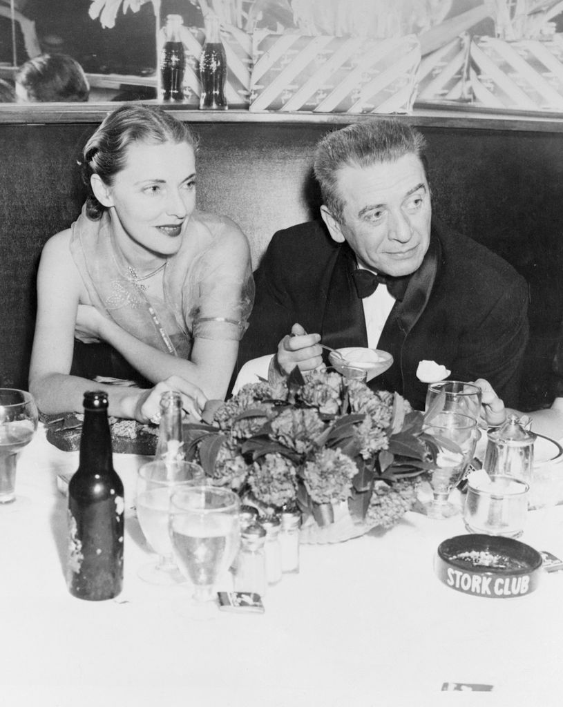 Theatrical producer Leland Hayward and beautiful Nancy Gross (Slim) Hawks, one of the 10 best dressed women in the world are shown at a recent appearance in the Stork Club, 1949