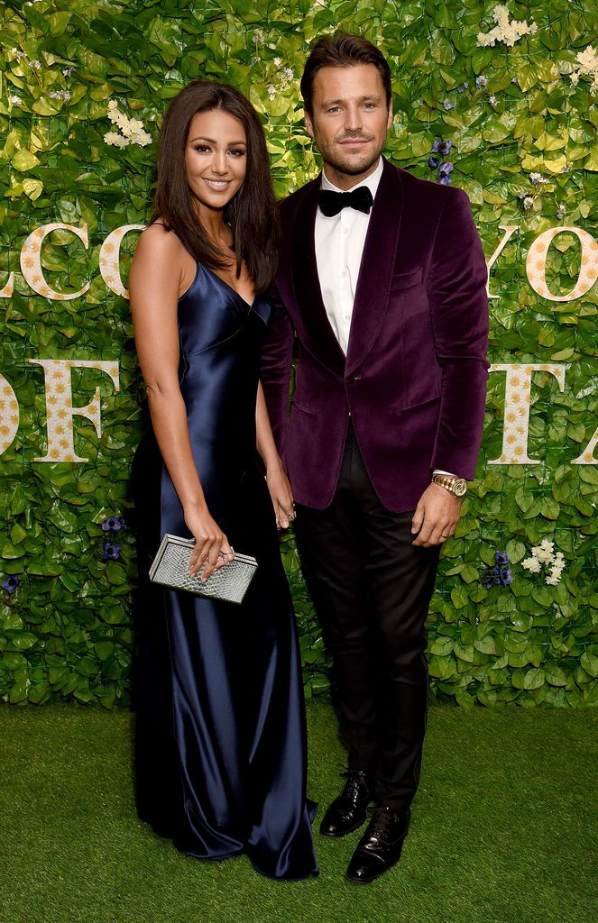 man and woman wearing smart clothes on green carpet 