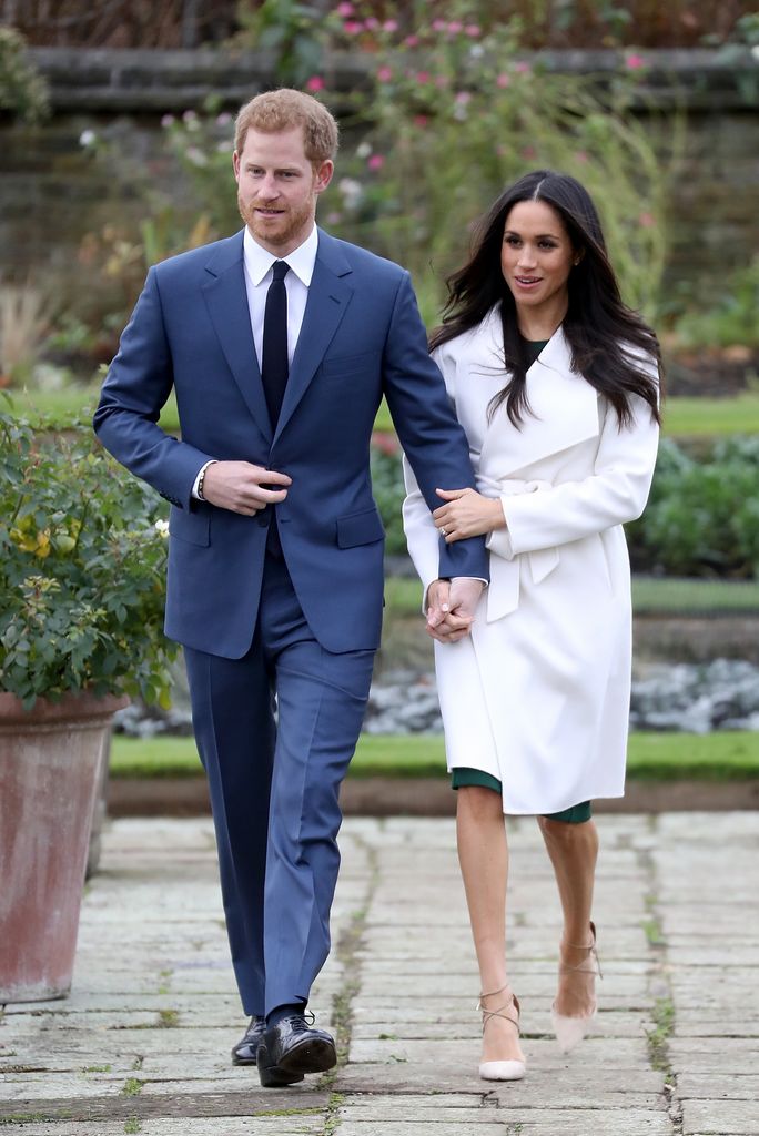   Prince Harry and actress Meghan Markle during an official photocall to announce their engagement at The Sunken Gardens at Kensington Palace on November 27, 2017 in London, England.  