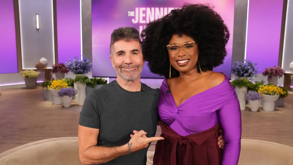 Simon Cowell in black t-shirt photographed with Jennifer Hudson in purple top