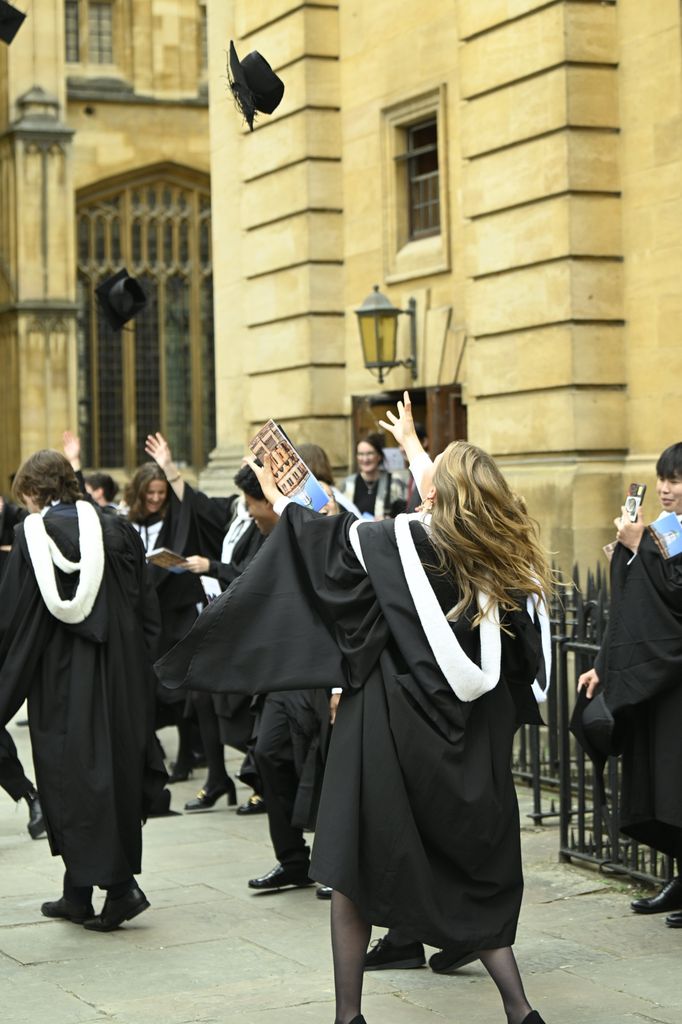 Princess Elisabeth throws mortar board in the air at graduation