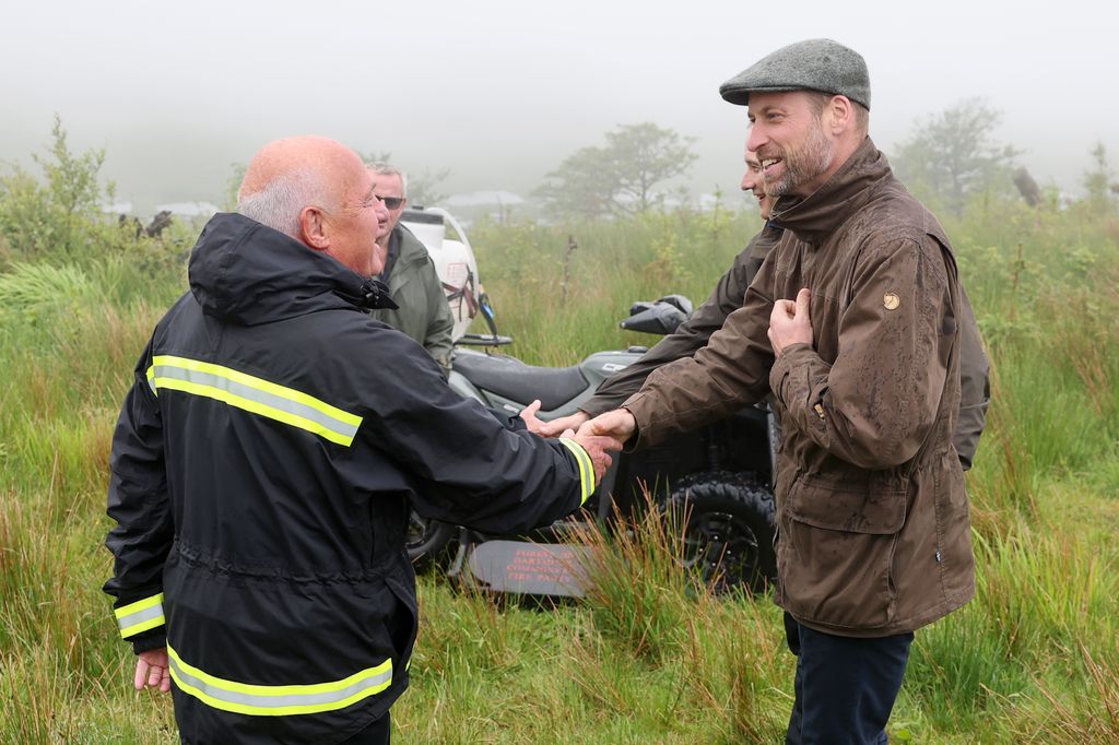 Prince William  meets a representative from the local Fire Service d