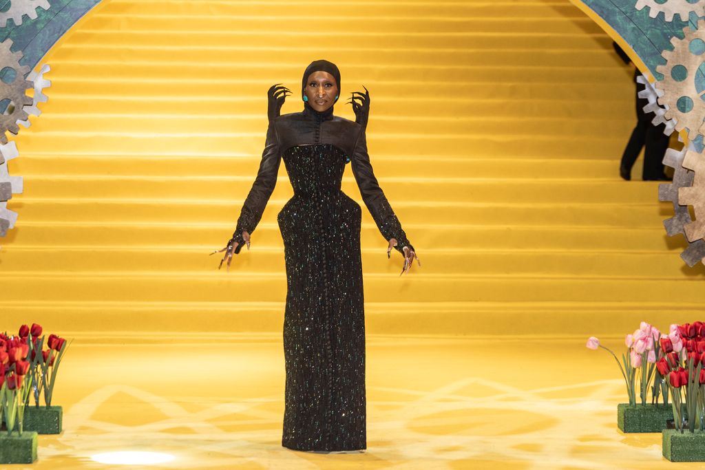 Cynthia Erivo poses on the yellow carpet in black gown