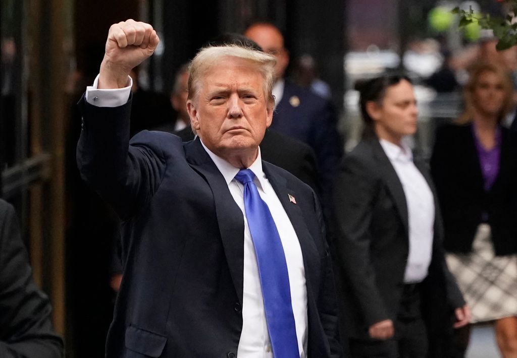 Former US President and Republican presidential candidate Donald Trump holds up a fist as he arrives back at Trump Tower after being convicted in his criminal trial in New York City, on May 30, 2024. A panel of 12 New Yorkers were unanimous in their determination that Donald Trump is guilty as charged -- but for the impact on his election prospects, the jury is still out. The Republican billionaire was convicted of all 34 charges in New York on May 30, 2024, and now finds himself bidding for a second presidential term unsure if he'll be spending 2025 in the Oval Office, on probation or in jail. (Photo by TIMOTHY A. CLARY / AFP) (Photo by TIMOTHY A. CLARY/AFP via Getty Images)