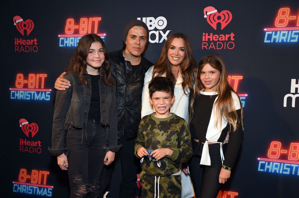 Edwin Arroyave (2L) and Teddi with their three children in 2022