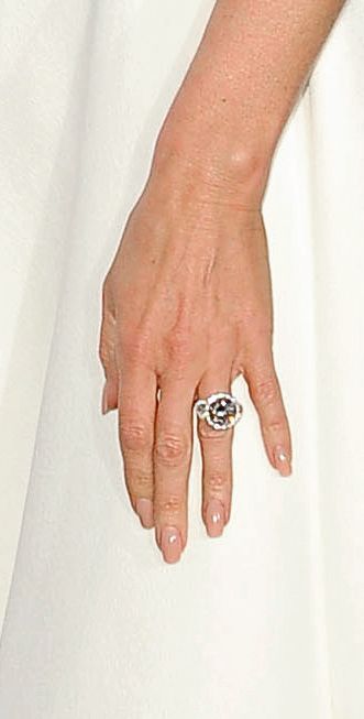 Victoria Beckham in a white dress and unusual diamond engagement ring