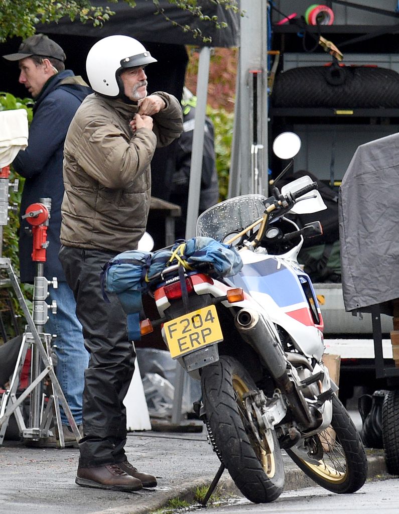 Three times Oscar winner Daniel Day Lewis looked unrecognisable with beard and moustache as he was filmed riding a motorbike with fellow star Sean Bean.