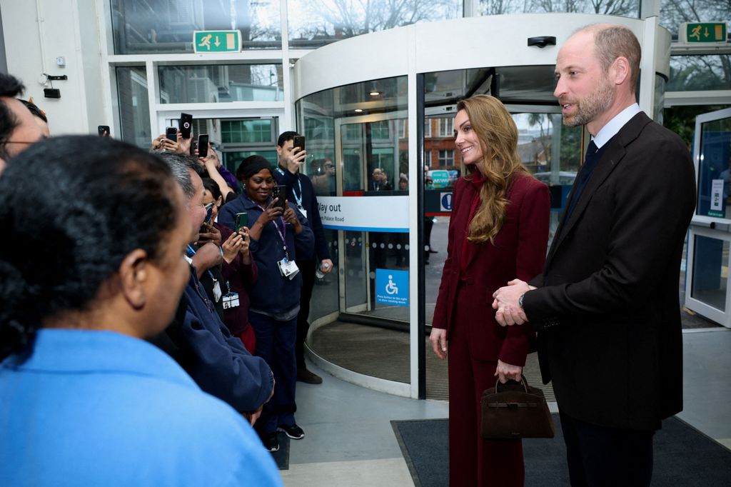 Britain's Prince William (R), Prince of Wales and Catherine (2nd R), Princess of Wales speak with staff at the end of their visit to Charing Cross Hospital