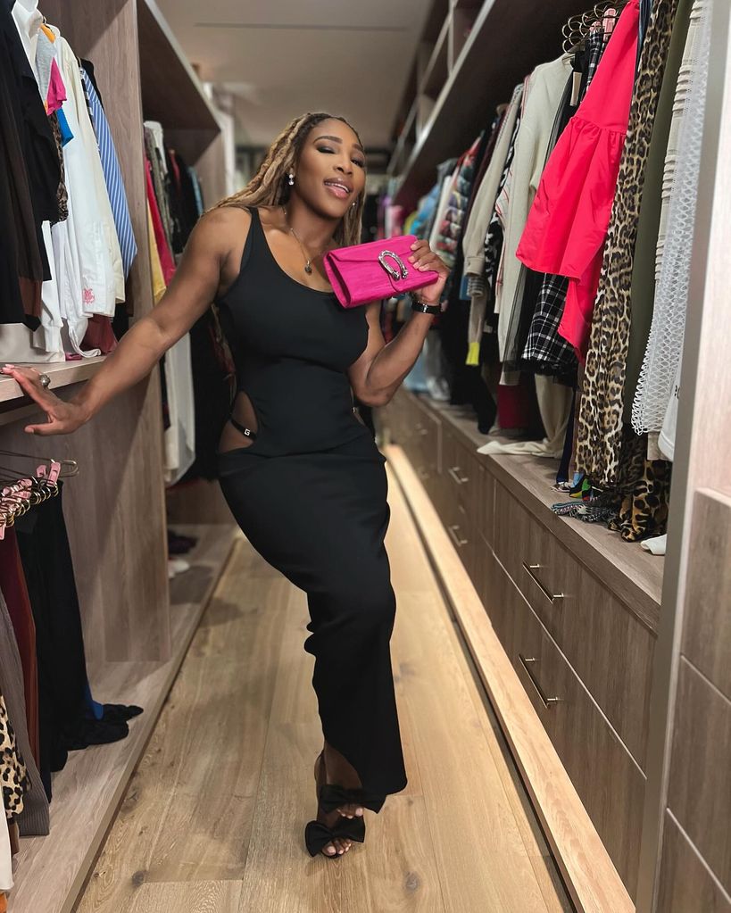 Serena in a LBD holding pink clutch 
