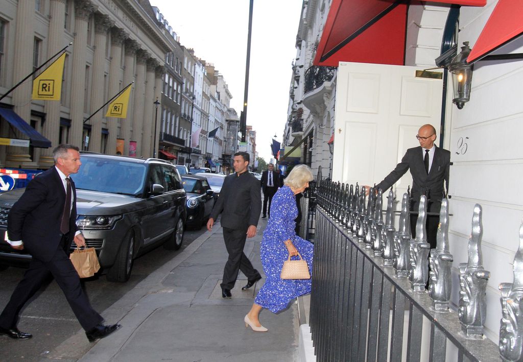 Faraway shot of Queen Camilla walking into a club