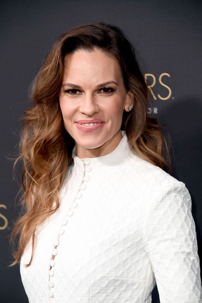 hilary swank white dress posing red carpet oscars party