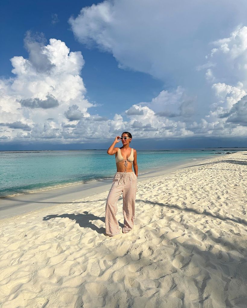woman standing on pristine beach 