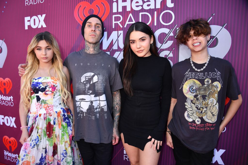 LOS ANGELES, CALIFORNIA - MARCH 14: (EDITORIAL USE ONLY. NO COMMERCIAL USE) (L-R) Alabama Barker, Travis Barker, Atiana De La Hoya and Landon Asher Barker attends the 2019 iHeartRadio Music Awards which broadcasted live on FOX at Microsoft Theater on March 14, 2019 in Los Angeles, California. (Photo by Jeff Kravitz/2019 iHeartMedia)