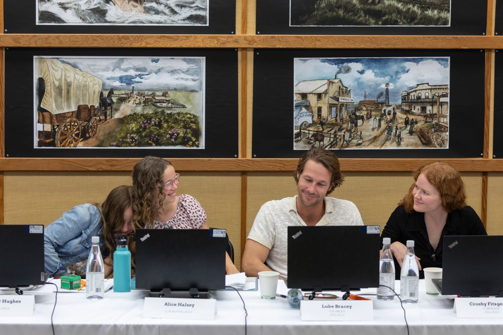 two young female actors with older male actor and female actor at table read