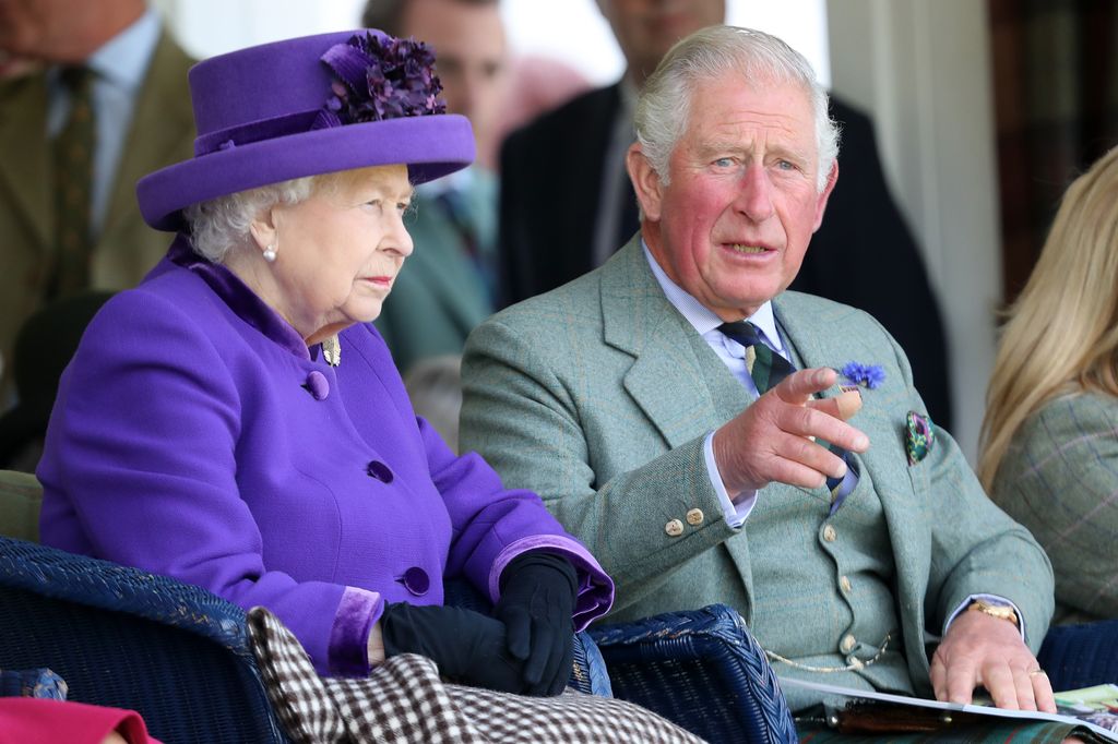 The Queen and Prince Charles sat at the Braemar Games
