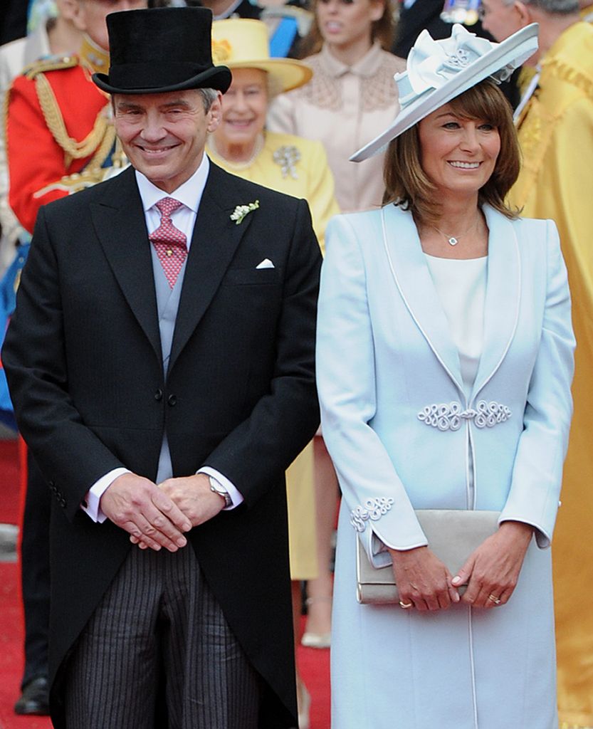 Carole Middleton in a blue coat dress and her husband Michael in a suit at the royal wedding