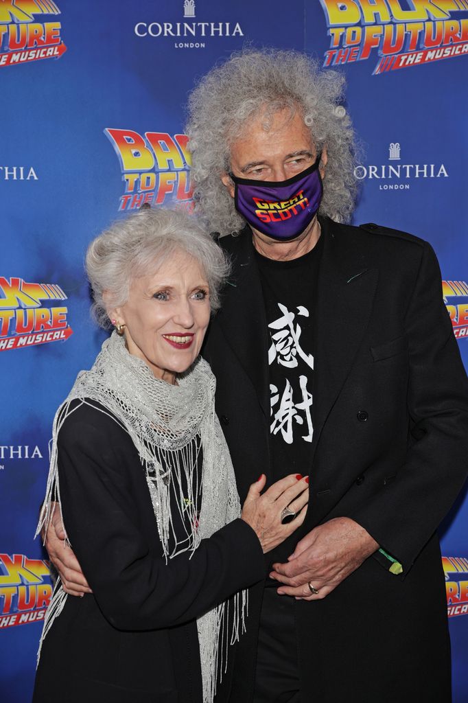 Anita Dobson standing with Brian May, who wears a facemask