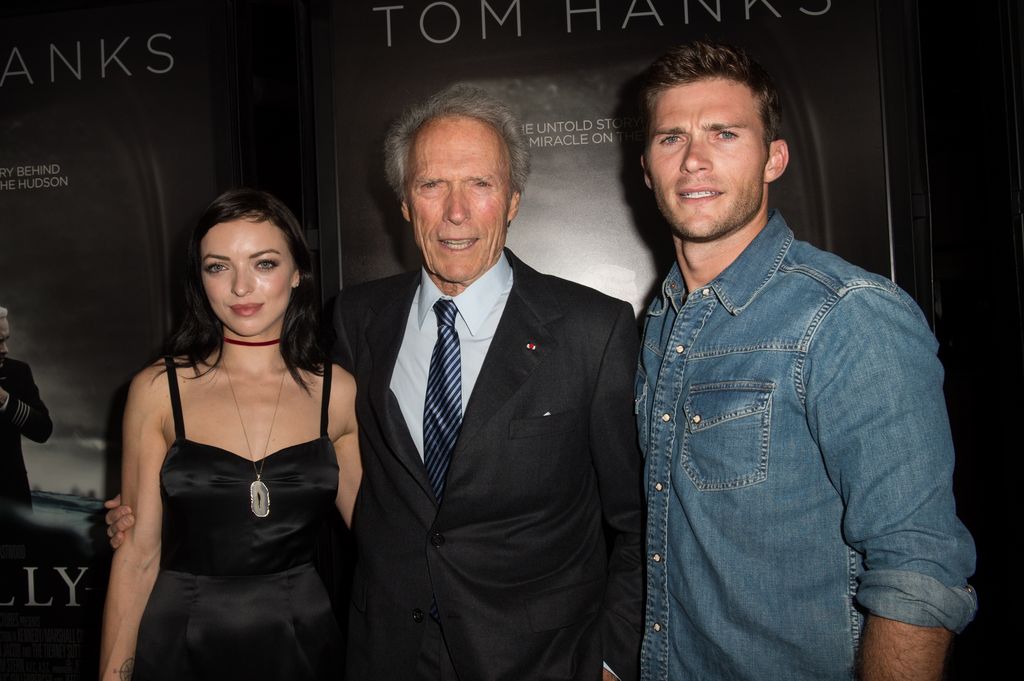 rancesca Eastwood, director/actor/producer Clint Eastwood, and actor/model Scott Eastwood with their arms around each other 