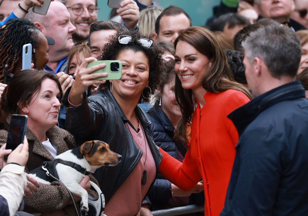 Kate takes a selfie with a member of the crowd