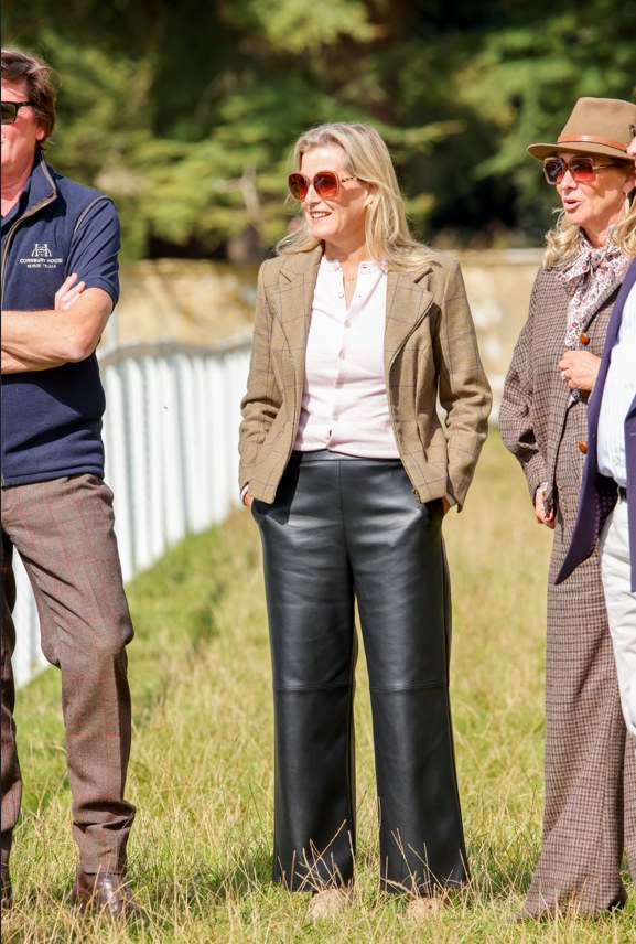 Duchess Sophie standing with two people in field