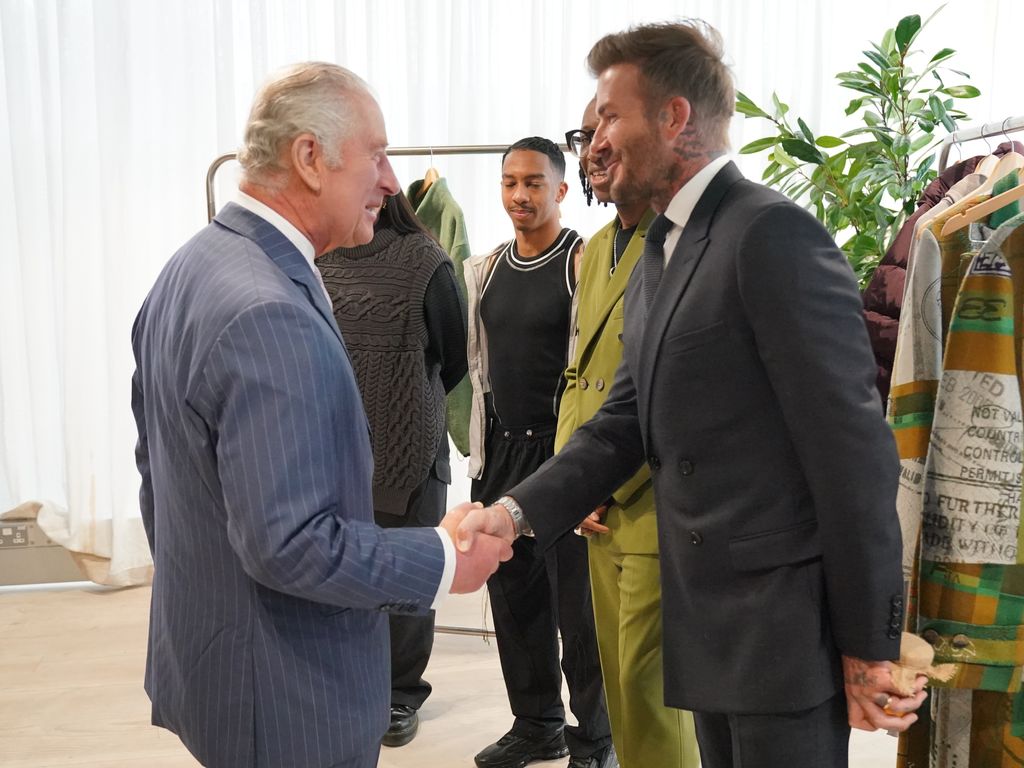 King Charles III shakes hands with David Beckham