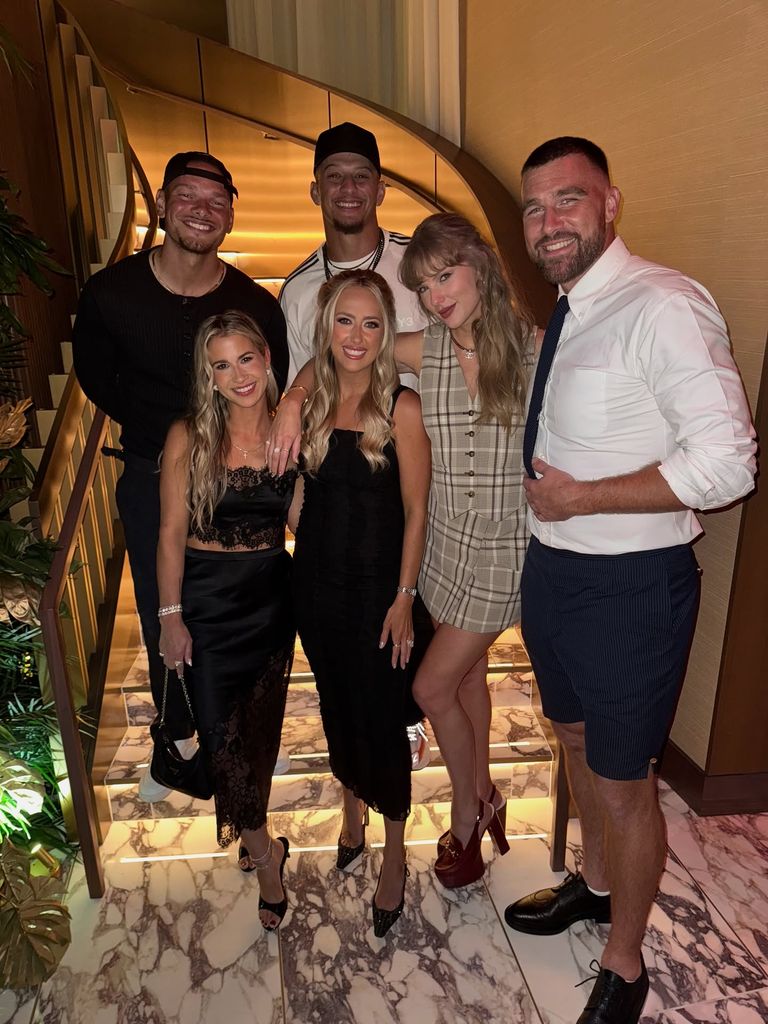 photo of taylor swift travis kelce brittany mahomes patrick mahomes kane brown standing on staircase