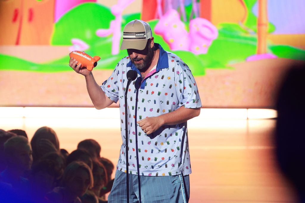 Adam Sandler accepts the award for Favorite Male Voice From An Animated Movie onstage at the 2024 Nickelodeon Kids' Choice Awards at Barker Hangar on July 13, 2024 in Santa Monica, California.