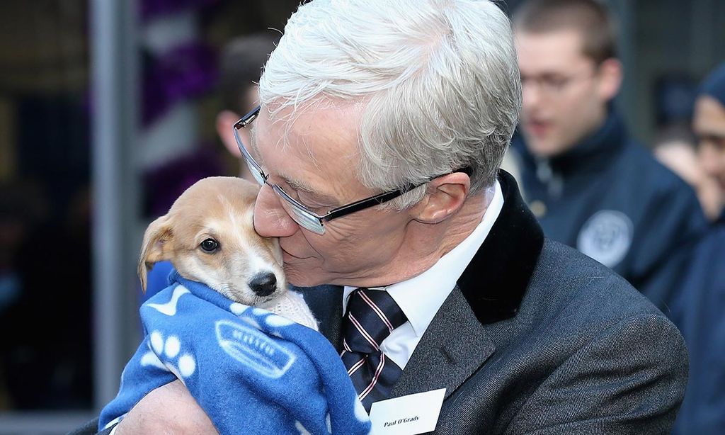 Paul O'Grady kisses a puppy