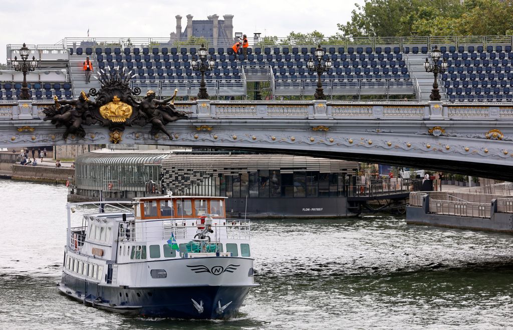 A boat going underneath a bridge in Paris