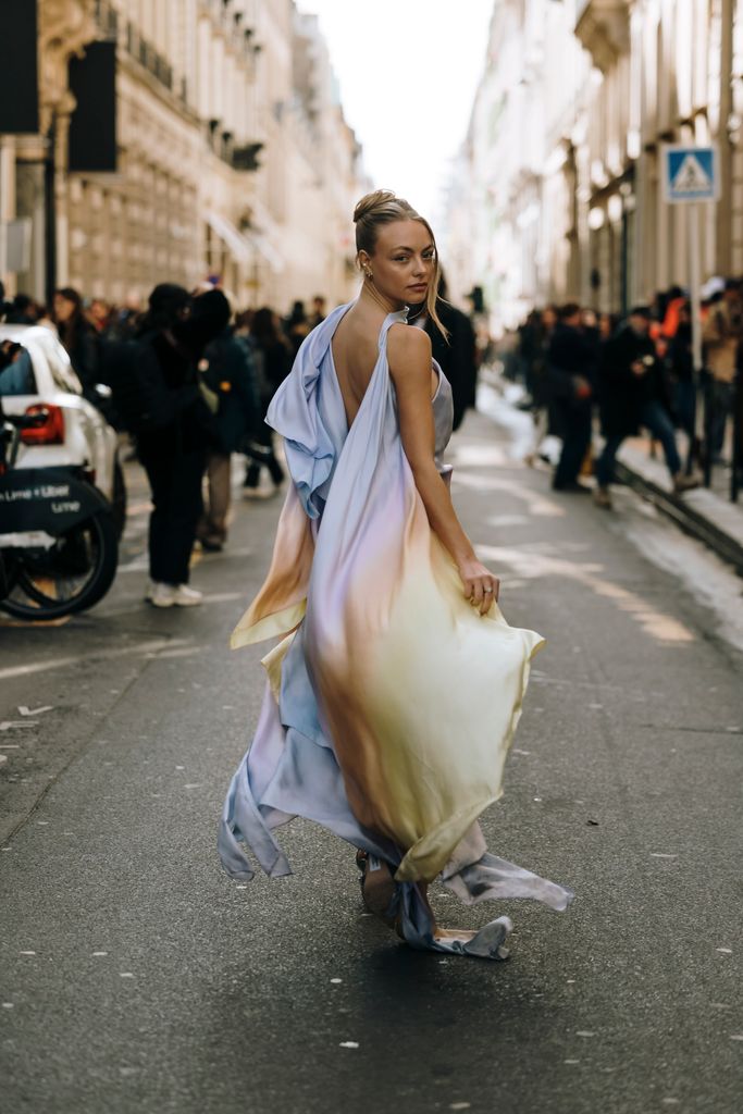 A Fashion Week attendee wearing a multicoloured ombre dress in Paris