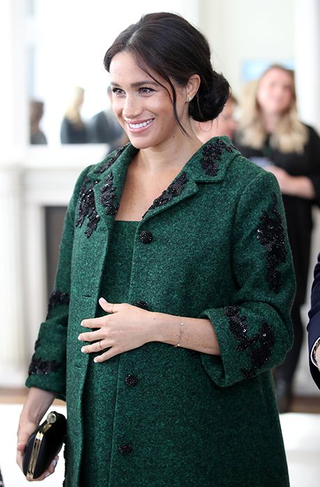 meghan markle cradling baby bump at canada house