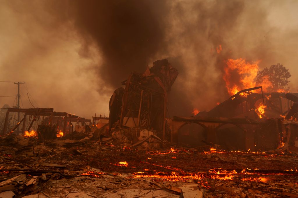 Flames from the Palisades Fire burn a church on in the Pacific Palisades neighborhood where Billy lost his home