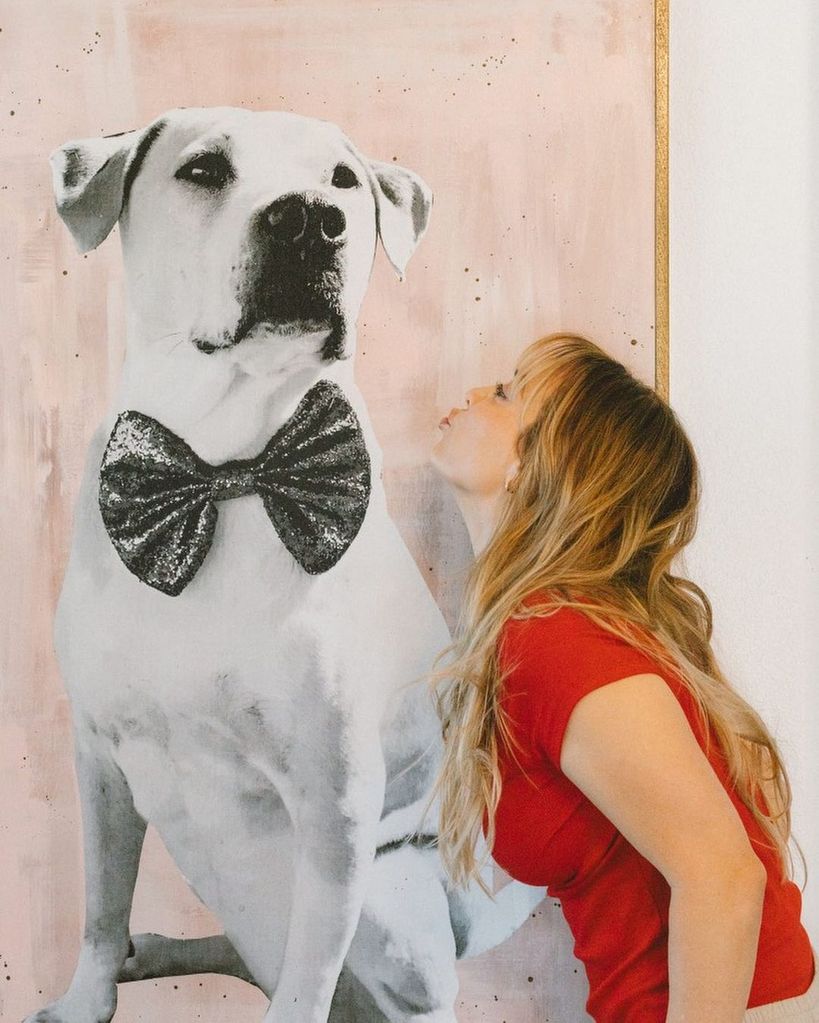 Kaley Cuoco kisses a portrait of dog Norman