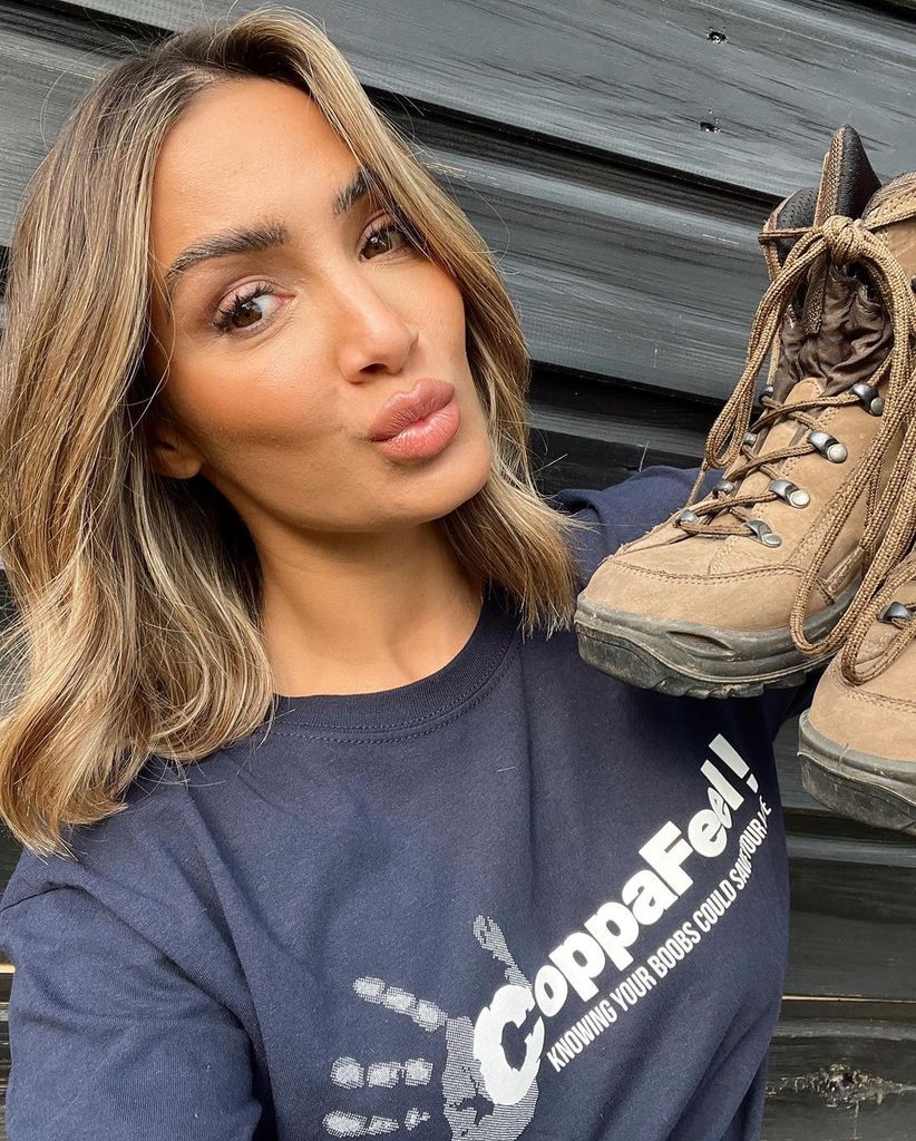 Frankie Bridge pouting with hiking boots