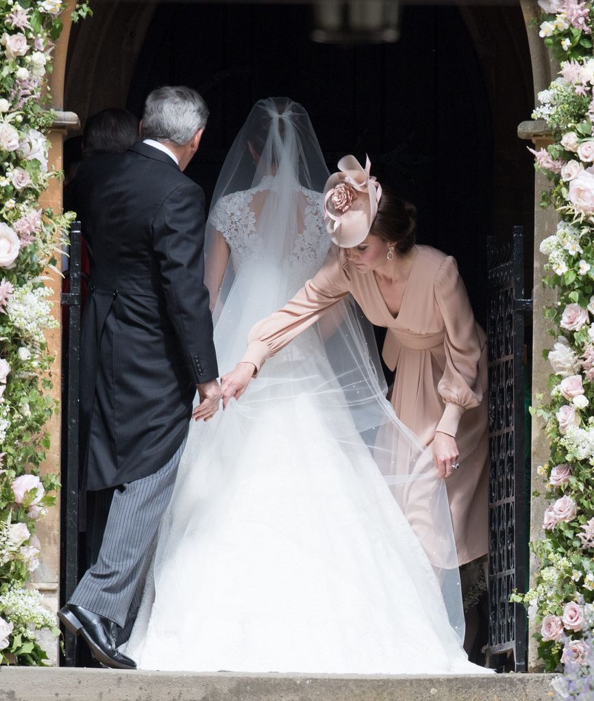 Kate adjusts Pippa's wedding dress and veil before the bride walked down the aisle
