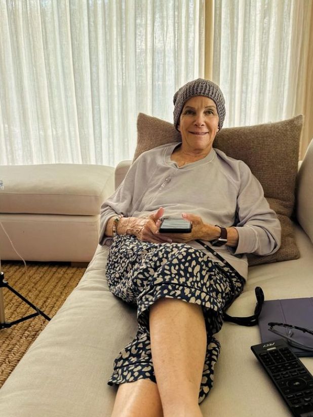 An elderly woman with cancer relaxing on a sofa