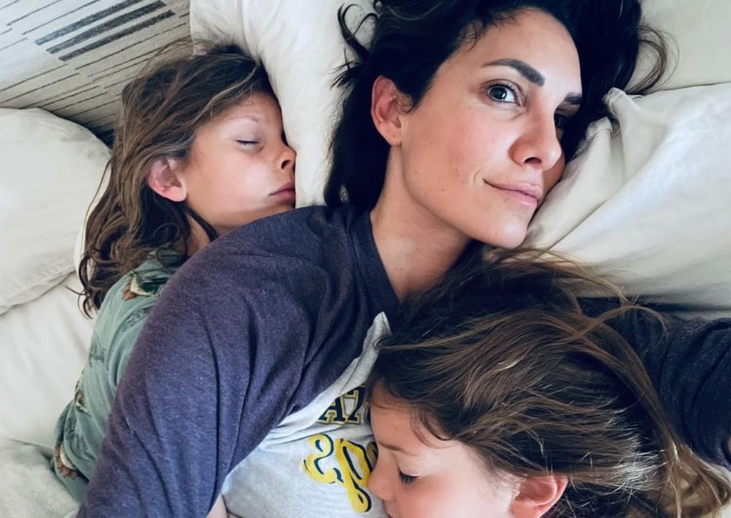 Photo shared by Daniela Ruah on Instagram in honor of Mother's Day cuddlign with her kids River and Esther