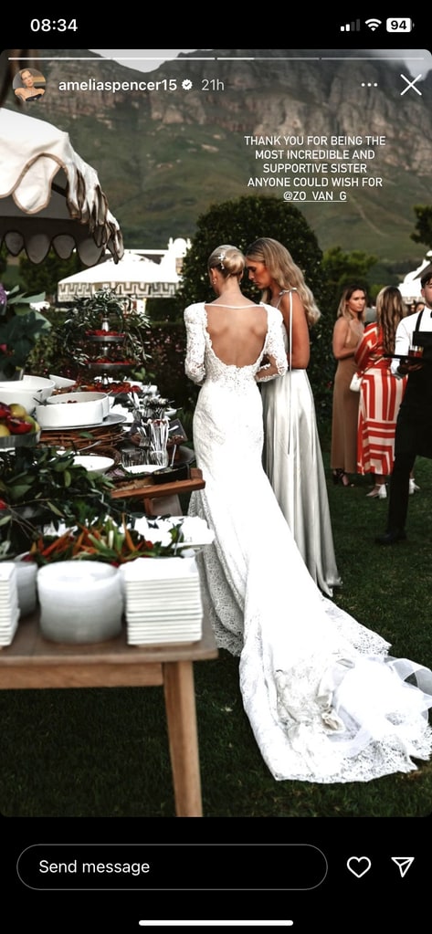 Lady Amelia Spencer in a wedding dress with her back to the camera near a food table