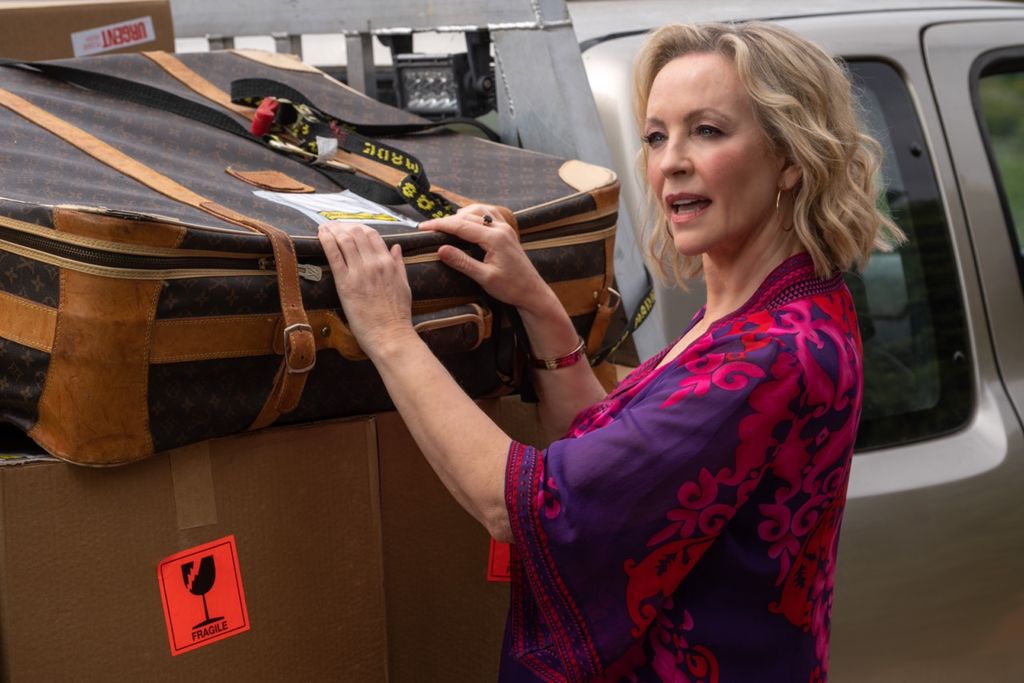 woman taking bag from back of truck