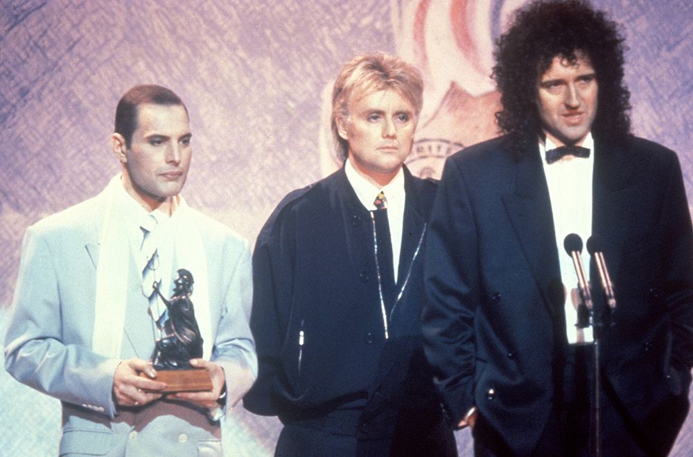 Freddie Mercury, Roger Taylor and Brian May on stage at the Brit Awards