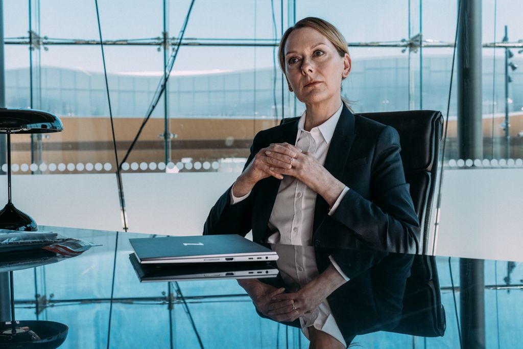 blonde woman sitting at desk 