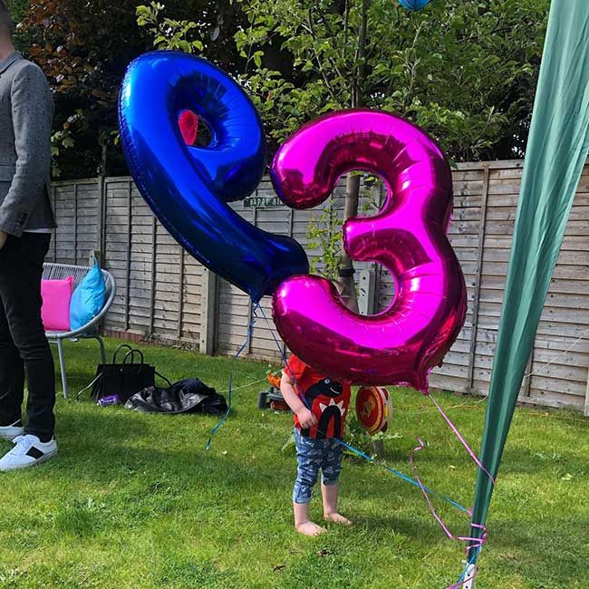 Stephs daughter holding the presenters birthday balloons