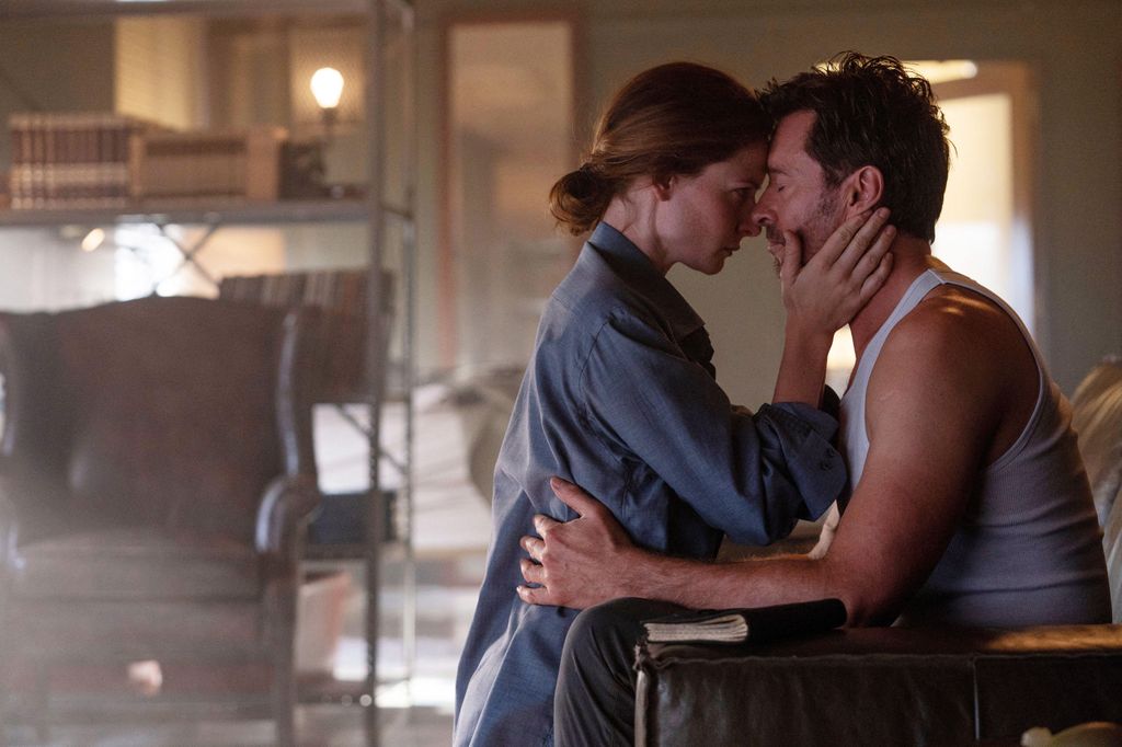 Rebecca Ferguson and Hugh Jackman embracing in a scene from Reminiscence